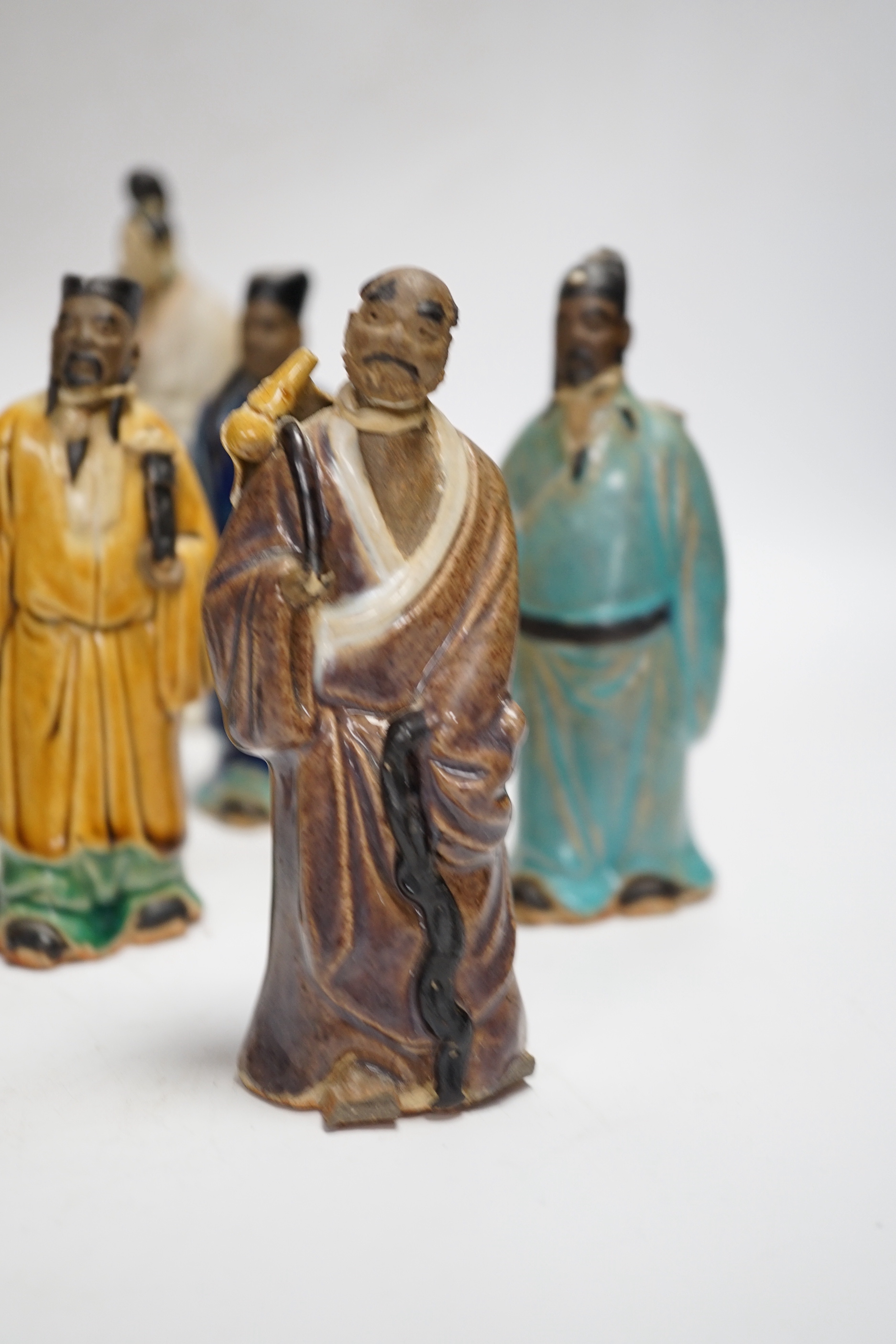 Fifteen Chinese Shiwan-type glazed pottery figures and carved stone figures, early 20th century, tallest 15cm